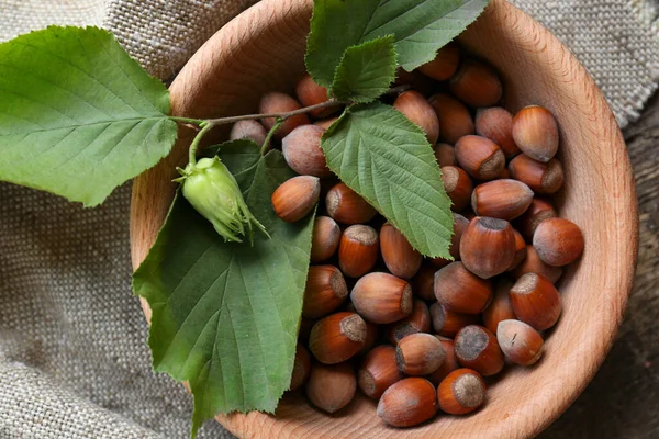 Tasty Hazelnuts Green Leaves Wooden Table Top View Healthy Snack — Fotografia de Stock
