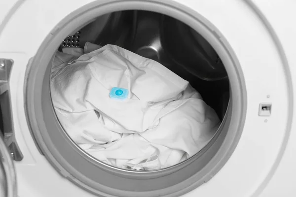 Water softener tablet on clothes in washing machine