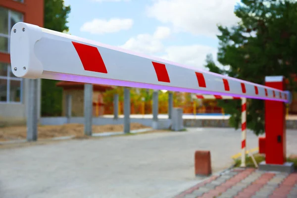 stock image Closeup view of closed automatic boom barrier outdoors, space for text