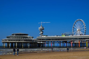 Lahey, Hollanda - 2 Mayıs 2022: Dönme dolaplı güzel sahil ve Scheveningen İskelesi manzarası