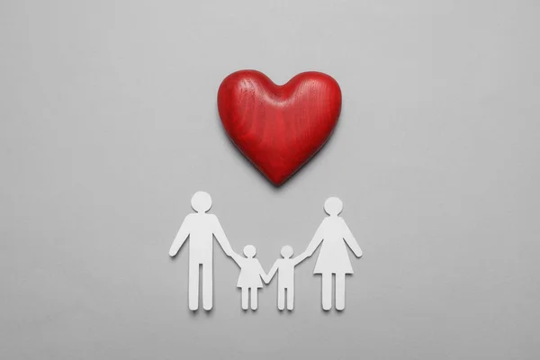 Paper family cutout and red heart on grey background, flat lay. Insurance concept