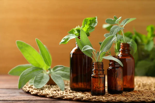 Bottles Essential Oils Fresh Herbs Wooden Table Space Text — Stock Photo, Image