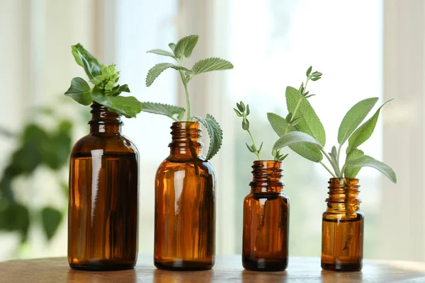 Lényeges Üvegek Friss Fűszernövények Fából Készült Asztalokon Zárt Térben — Stock Fotó