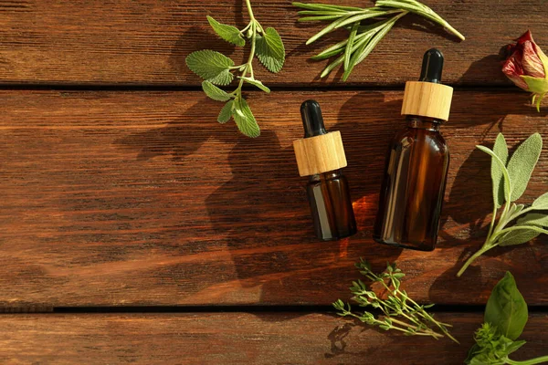Bottles Essential Oil Fresh Herbs Wooden Table Flat Lay Space — Stock Photo, Image