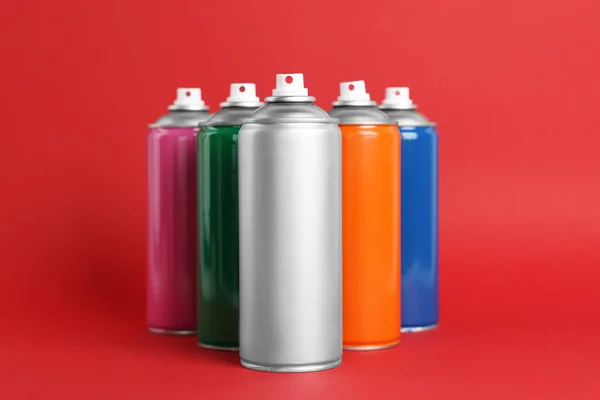 Colorful Cans Spray Paints Red Background — Stock Photo, Image