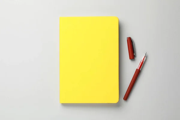 Yellow Notebook Pen Gray Background Flat Lay Royalty Free Stock Photos