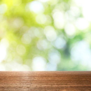 Bulanık yeşil arka planda boş ahşap yüzey. Bokeh etkisi