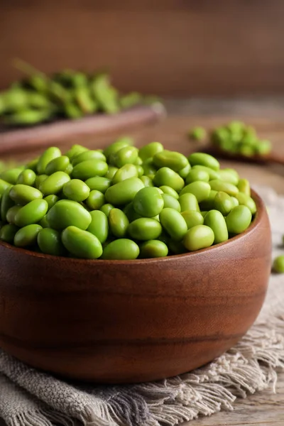 stock image Bowl of delicious edamame beans on wooden table, closeup