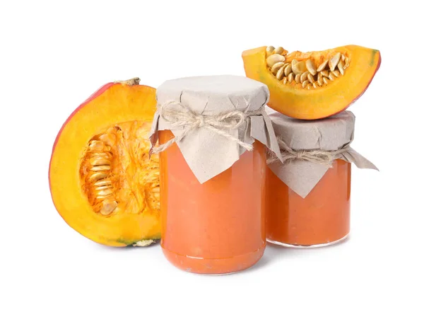 stock image Jars of pumpkin jam and fresh pumpkin on white background