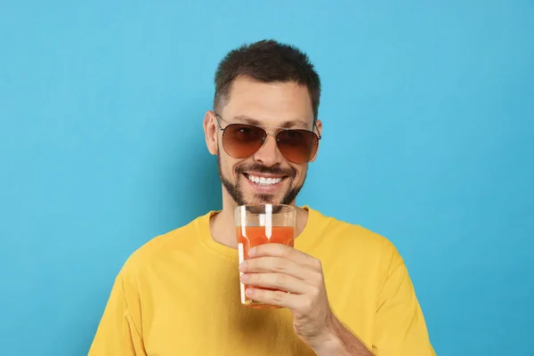 Man Drinking Delicious Juice Light Blue Background — Stock Photo, Image