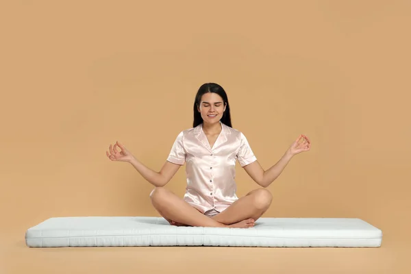 Mujer Joven Meditando Sobre Colchón Suave Sobre Fondo Beige —  Fotos de Stock