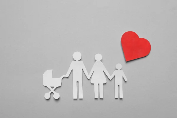 Paper family cutout and red heart on grey background, flat lay. Insurance concept
