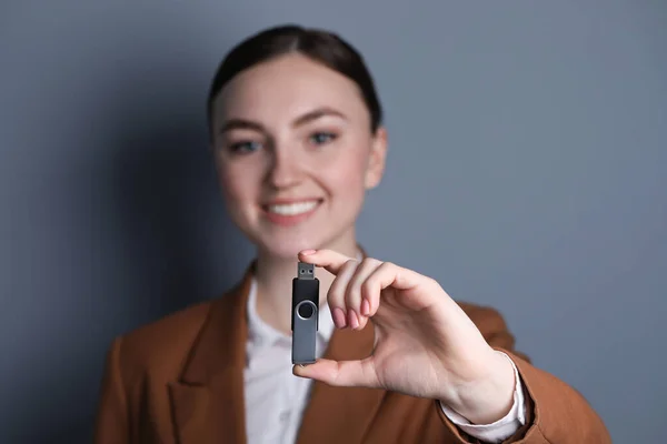 Woman Holding Usb Flash Drive Grey Background Closeup — Stock Photo, Image