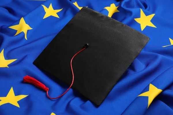 stock image Black graduation cap on flag of European Union