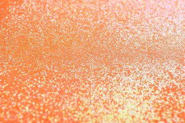 Turuncu arka planda parlak parıltı, yakın plan.