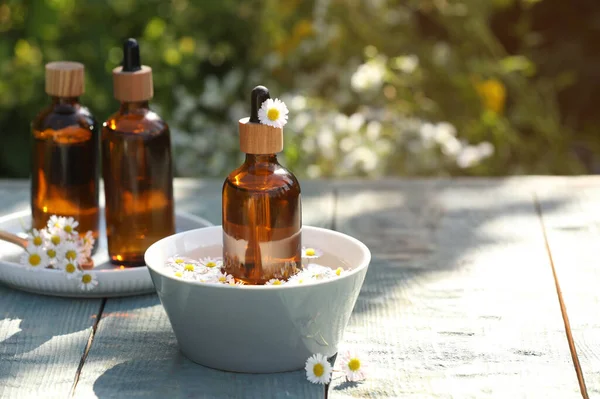 Bottles Chamomile Essential Oil Flowers Grey Wooden Table Space Text — Stock Photo, Image