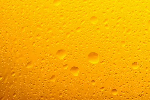 stock image Glass of tasty cold beer with condensation drops as background, closeup