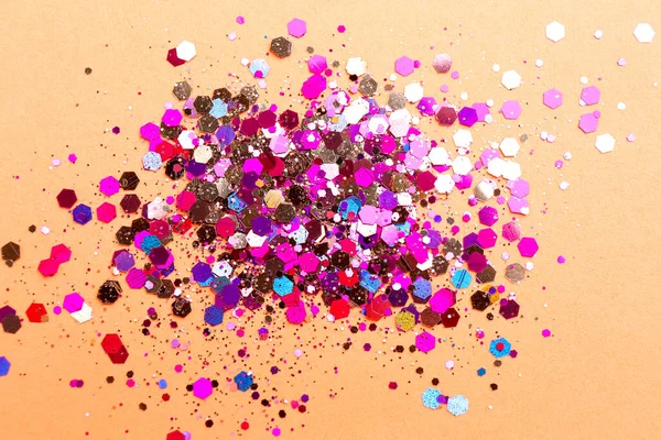 Stock image Shiny bright glitter on coral background, flat lay