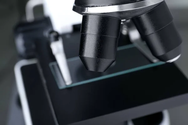 Modern medical microscope with glass slide, closeup
