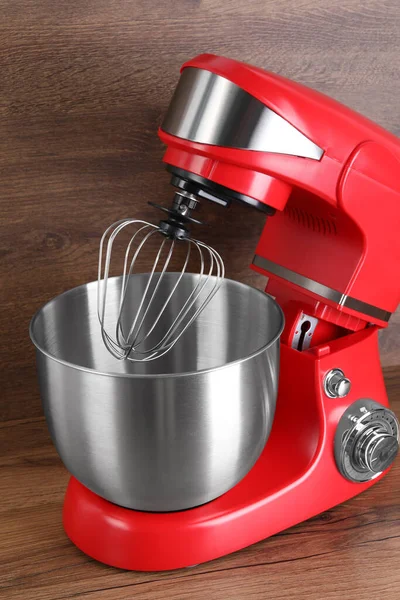 Modern red stand mixer on wooden table