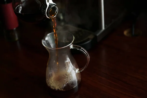 カフェの木のテーブルの上にコーヒーをグラスに入れる — ストック写真