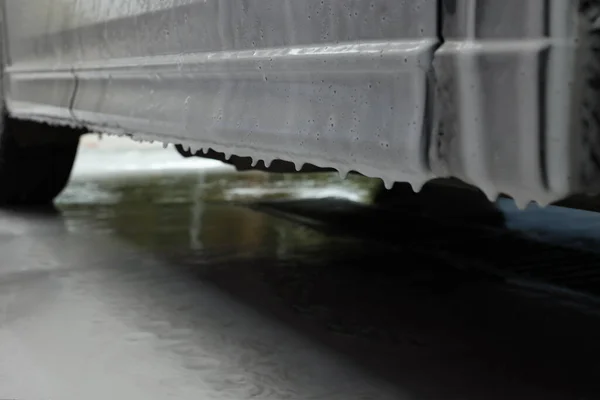 stock image Auto with cleaning foam at car wash, closeup