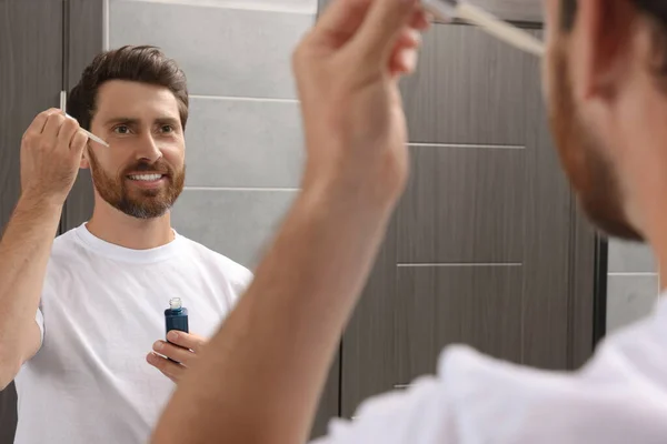 Bonito Homem Aplicando Óleo Barba Banheiro — Fotografia de Stock