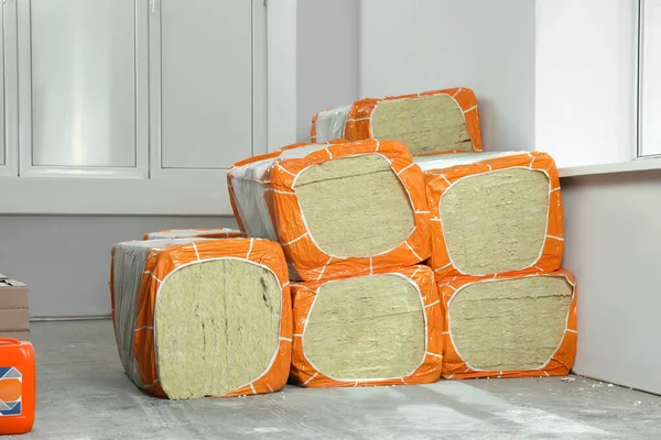 stock image Stacked packages of thermal insulation material in room