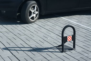 Parking barrier with No Stopping road sign on pavement near car, space for text clipart