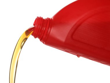 Pouring motor oil from red container isolated on white