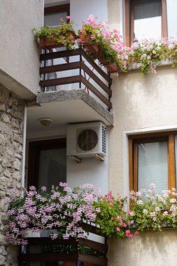 Balkonları ve çiçekleri olan güzel bir apartmanın dış cephesi.