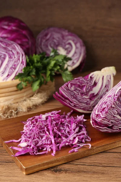 Cut fresh red cabbage on wooden table