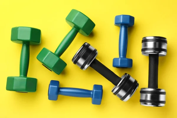 Many Different Stylish Dumbbells Yellow Background Flat Lay — 스톡 사진