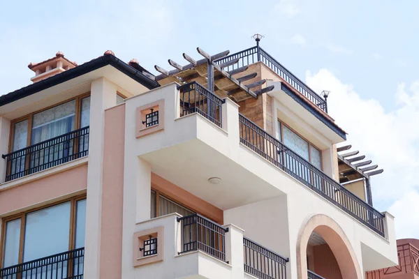 stock image Exterior of residential building with balconies against blue sky, low angle view