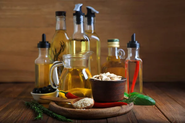 Different cooking oils and ingredients on wooden table