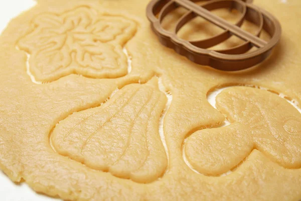 stock image Cookie cutter and dough on white table, closeup