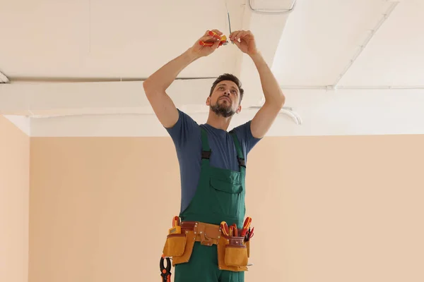 Electrician Uniform Pliers Repairing Ceiling Wiring Indoors — Stock Photo, Image