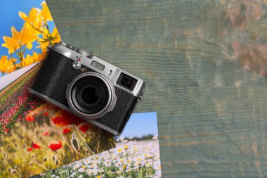 Antika fotoğraf makinesi ve ahşap masada basılmış güzel resimler. Düz yerde, mesaj için yer var. Yaratıcı hobi