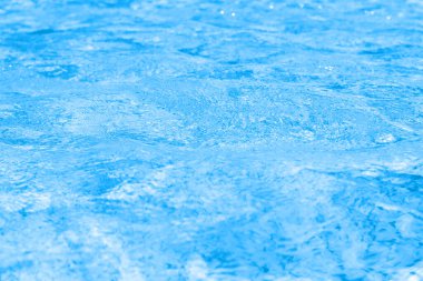 Rippled water in swimming pool as background