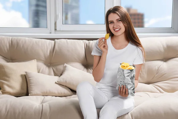 Pretty Young Woman Eating Tasty Potato Chips Sofa Home — Stock Photo, Image