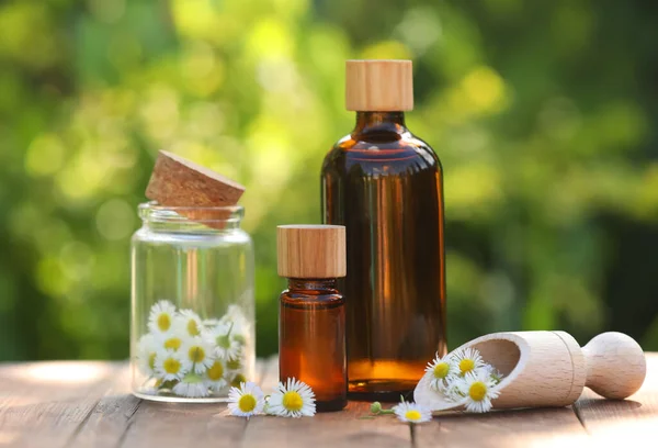Bottles Chamomile Essential Oil Flowers Wooden Table — Stockfoto