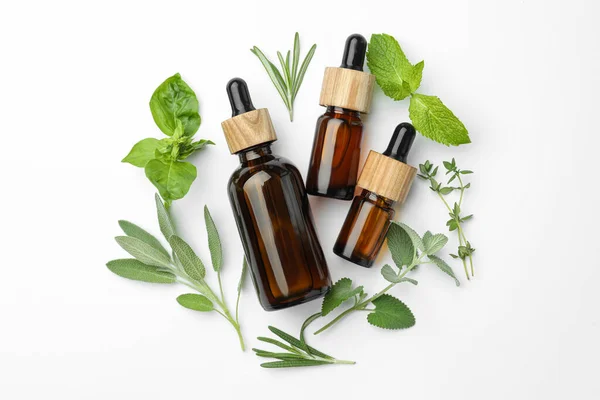 Bottles Essential Oil Fresh Herbs White Background Flat Lay — Fotografia de Stock