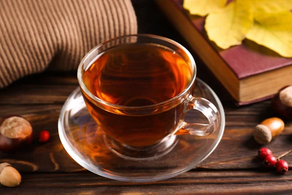 Cup Aromatic Tea Book Acorns Wooden Table Indoors Closeup Autumn — Stock Photo, Image
