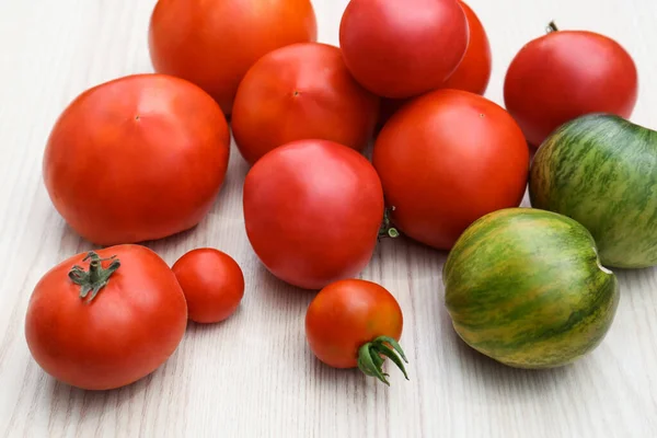 Viele Verschiedene Reife Tomaten Auf Weißem Holztisch — Stockfoto