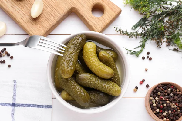 stock image Tasty pickled cucumbers and ingredients on white wooden table, flat lay