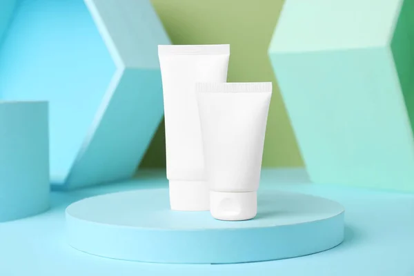 stock image Composition with tubes of hand cream on light blue table