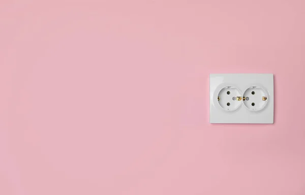 stock image Double power socket on pink wall, space for text. Electrical supply