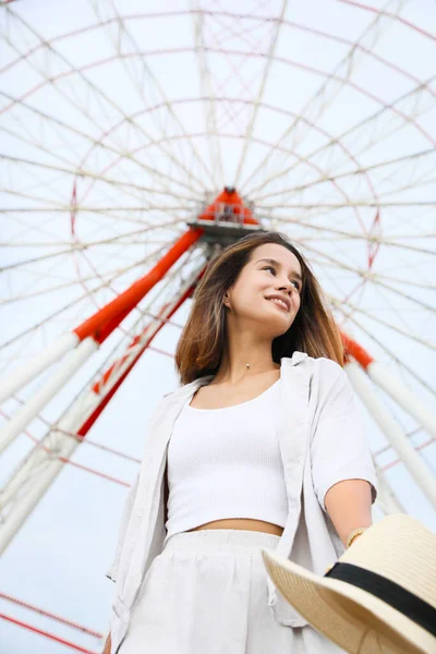 stock image Beautiful young woman near Ferris wheel outdoors, low angle view