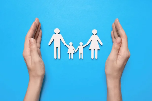 Woman Protecting Figures Family Light Blue Background Top View Insurance — Stock Photo, Image