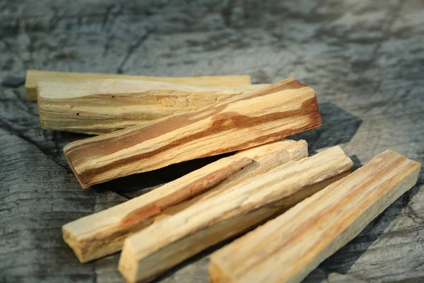 Palo santo sticks on wooden table, closeup